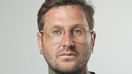 Handsome person look at camera close up. Young adult man face portrait. Stylish 30s guy on isolated white background. Attractive male model. Modern millennial people. Brutal bearded style. Barber shop