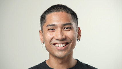 Handsome person look at camera close up. Young adult man face portrait. Stylish 30 years old guy on...