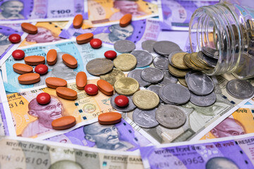 Health care financial checkup or saving for medical insurance bills - cash with pills close up