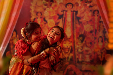 Mother and daughter celebrating Durga Puja