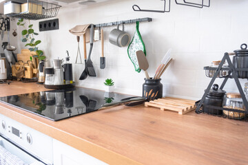 Light white modern rustic kitchen decorated with potted plants, loft-style kitchen utensils....