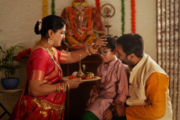 Maharashtrian family worshiping  Lord Ganesha on the occasion of Ganesh Chaturthi