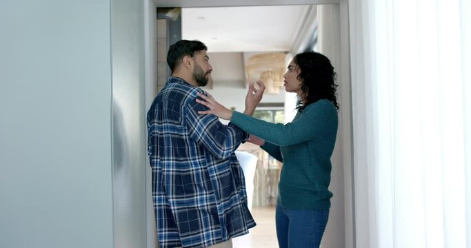 Biracial couple arguing in hall at home, in slow motion