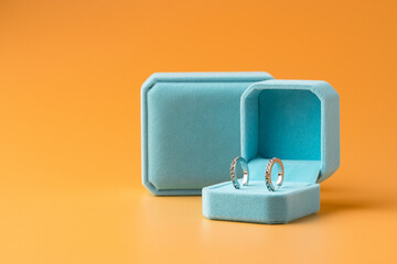 Blue jewelry box on yellow background close up
