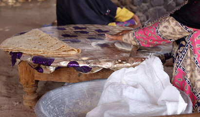 Making traditional  bedouin flat bread on an open fire in Egypt.