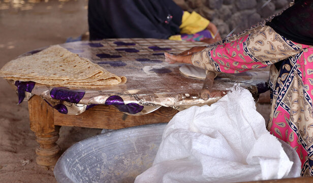 Making traditional  bedouin flat bread on an open fire in Egypt.