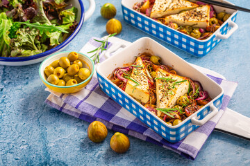 Baked sheep cheese, feta cheese with olives, figs, onions and green salad