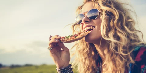 Fotobehang Captivating young, cool blonde woman indulging in pizza amidst nature, rendered in desaturated cold hues giving it a serene, free-spirited, and peaceful hippie vibe. © XaMaps