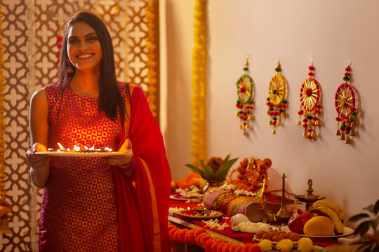 Woman worshipping (Goddess Laxmi, goddess of wealth ) on the during  Diwali celebrations