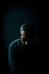 Man looking down sad and gloomy