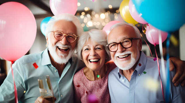 Portrait of happy group of senior people smiling and celebrating a birthday party with balloons and cake at a retirement home. Elderly people lifestyle - Powered by Adobe