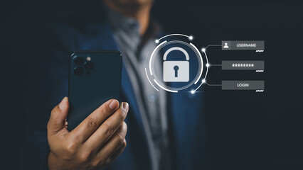 Businessman holding smartphone with digital shield padlock protection login screen on internet technology virtual interface services. Cyber security network protection concept.