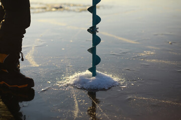 Ice ax - ice screws on winter fishing on the ice caves. Ice is very clean and beautiful. The Lake Baikal.