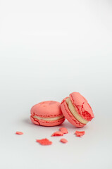 crushed pink macaroons on a white background