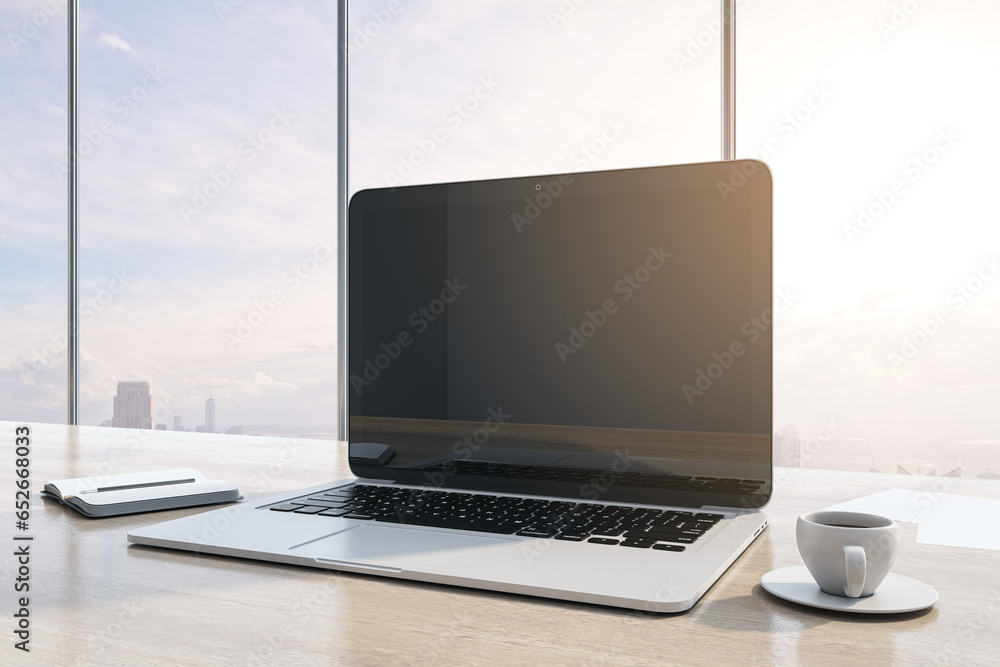 Poster Close up of workplace with empty mock up laptop screen, supplies, coffee cup and panoramic window with city view in the background. 3D Rendering.