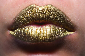 Gold lips. Gold paint on mouth. Golden lips. Luxury gold lips make-up. Golden lips with creative...
