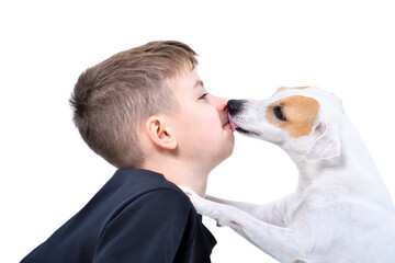 Portrait of a cute boy being licked by a dog isolated on white background