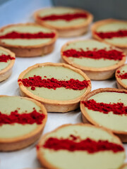 Mini-tarts with pistachio cream and dry berries close-up. Beautiful dessert