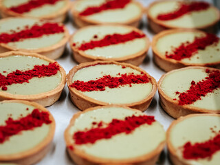 Mini-tarts with pistachio cream and dry berries close-up. Beautiful dessert