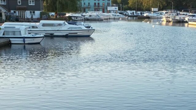 Boats on the River Bure in Wroxham in the heart of the Norfolk Broads. Captured early morning at sunrise