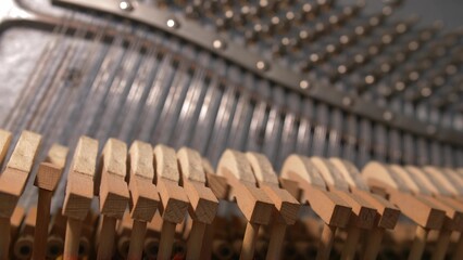 Upright Piano Mechanism Hammers Striking Strings When Song is Played by Musician