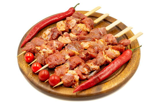 Lamb skewers isolated on white background. Raw lamb skewer with herbs and spices. Local name kuzu kusleme. Close up