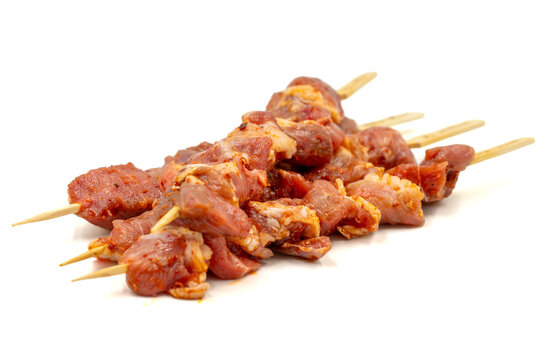 Lamb skewers isolated on white background. Raw lamb skewer with herbs and spices. Local name kuzu kusleme. Close up