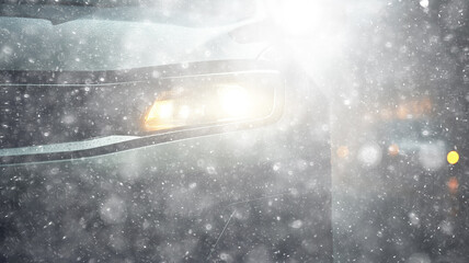 snowfall, car, background in a snowstorm with a copy of the space, the headlights of an oncoming car through a thick snowfall, winter view on the highway, headlight light