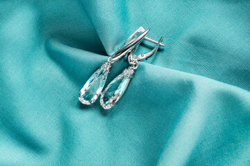 Crystal earrings on fabric