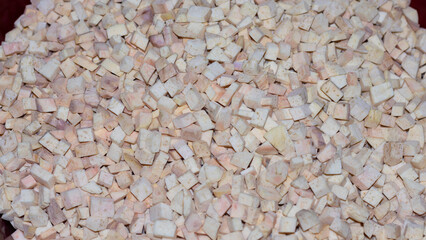 A pile of sweet potato slices on the table.