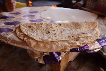Making traditional  bedouin flat bread on an open fire in Egypt.