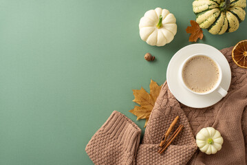 Embrace Autumn morning mood with top view shot showcasing warm knitted sweater, steaming cup of...