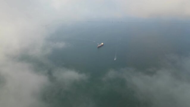 Container ship view from morning fog cloud at Malacca Straits