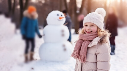 Blonde girl building snowman at the crowded park in winter