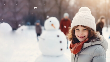 Brunette girl building snowman at the crowded park in winter