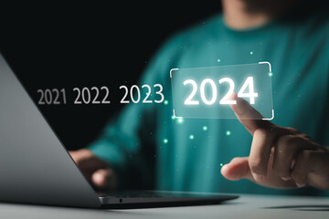 Market trend for 2024. Businessman touching virtual number 2024 for Merry christmas and happy new year concept. End of the old year and start of new business in 2024. - obrazy, fototapety, plakaty