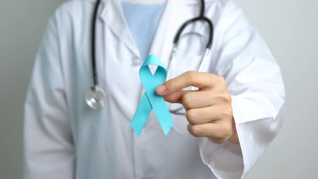 Blue November Prostate Cancer Awareness month, Doctor with Blue Ribbon in hospital for support people life and illness. Healthcare, International men, Father, Diabetes and World cancer day