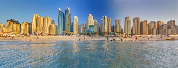 Panoramic view over beach and skyline of Marina district in Dubai during sunset