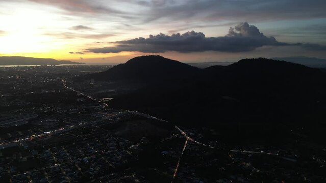 Sunset and light trail over a Machang Bubuk, Penang with hill in the background