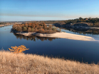 Island in the autumn forest with reflection