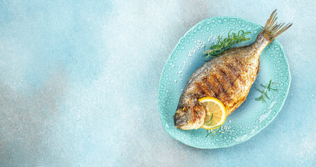 Grilled dorado fish and vegetables. Healthy food. roasted dorado. Long banner format. top view