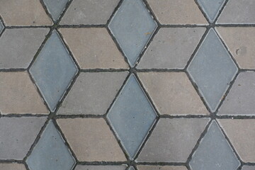 Surface of ornamental pavement made of brown and grey concrete blocks