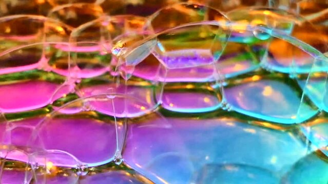 Soap bubbles on red blue and pink light background. Abstract macro background/ transition/ overlay.