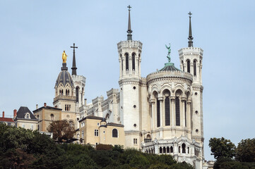 Basilica of Notre-Dame de Fourviere and tower of Chapelle Saint Thomas - Sainte Marie in Lyon city,...