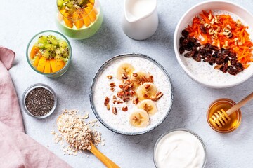 Overnight oats with fruits and nuts on concrete table top