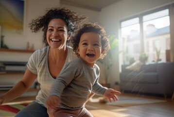 Curly diverse Latino or African American mother and her toddler playing at home with copyspace for happy family time together in sunny living room