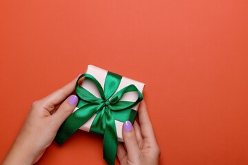 Woman Manicured Hands Holding Green Gift