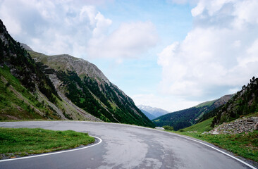 Asphalt road in Alps mountains. Road trip concept. Beautiful landscape.