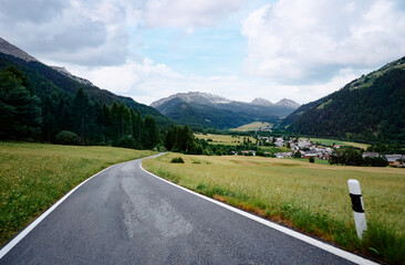 Fototapeta premium Asphalt road in Alp mountains. Road trip concept. Beautiful landscape.