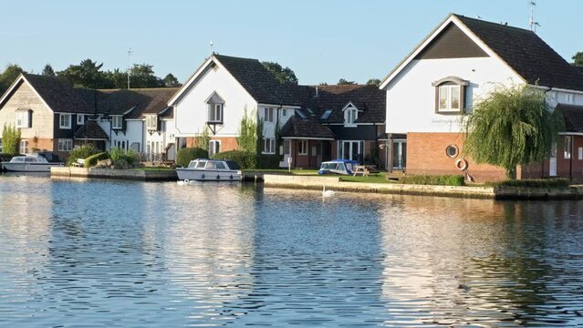 Waterside rental properties on the bank of the River Bure in the heart of the Norfolk Broads. Captured early morning at sunrise